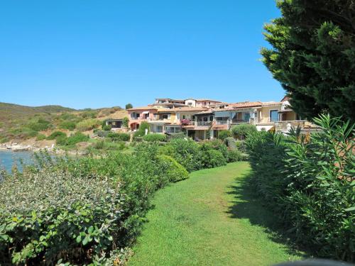 a house on a hill next to the water at Apartment Ginestra by Interhome in Casa Tamponi