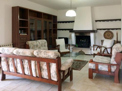 sala de estar con sofá, sillas y chimenea en Holiday Home Goleri - BSD100 by Interhome, en Bari Sardo