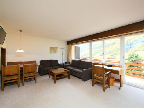 a living room with a couch and a table at Apartment Ringstrasse Apt 412 by Interhome in Leukerbad