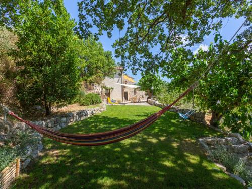 a hammock hanging from a tree in a yard at Holiday Home Rosario by Interhome in Gessopalena