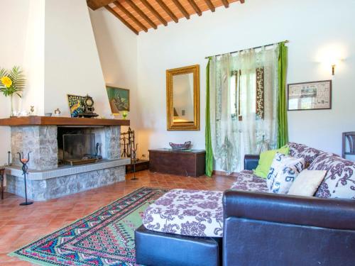 a living room with a blue couch and a fireplace at Holiday Home Cedri Alti-4 by Interhome in Ambra