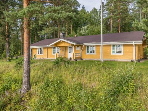 una casa amarilla en medio de un campo en Holiday Home Konnusmaja by Interhome, en Leppävirta