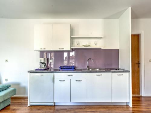 a kitchen with white cabinets and a sink at Apartment File-4 by Interhome in Zambratija
