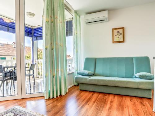 a living room with a couch and a balcony at Apartment File-4 by Interhome in Zambratija