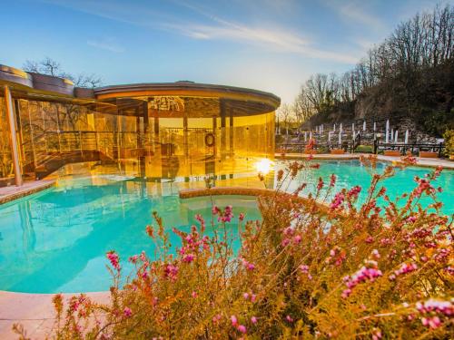 a large swimming pool with a gazebo at Holiday Home Thermae Villa 34 by Interhome in Sorano