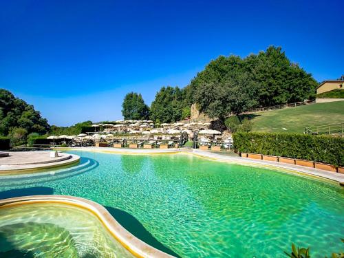 a swimming pool with blue water in a resort at Holiday Home Thermae Villa 36 by Interhome in Sorano