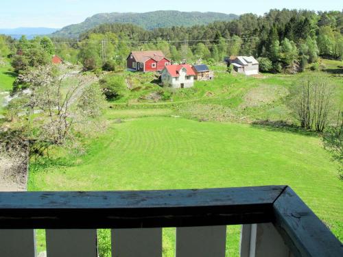 a view of a green field with houses on a hill at Holiday Home Gule huset by Interhome in Bruntveit