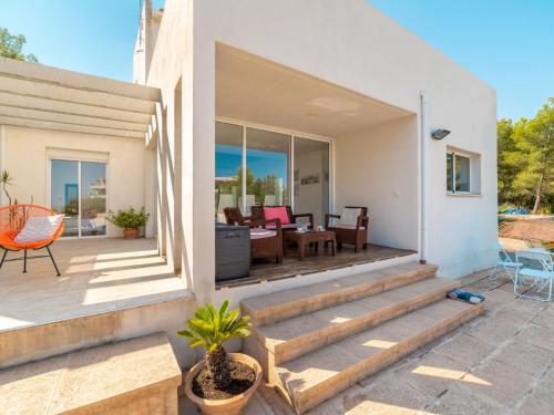 a home with a patio with a table and chairs at Villa Betlem by Interhome in Colonia de Sant Pere