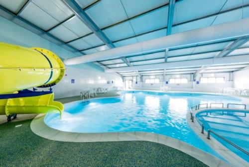 a large indoor swimming pool with a slide at willerby lamberhurst in Kent