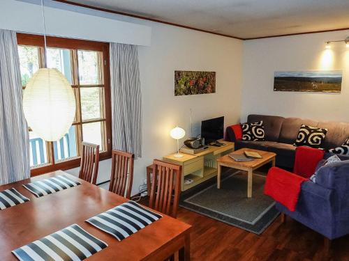 a living room with a couch and a table at Holiday Home Saariseläntie 8 a 1 by Interhome in Saariselka