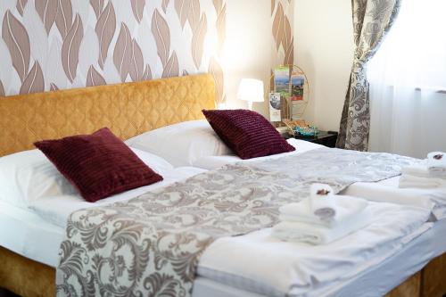 a bedroom with two beds with towels on them at Penzión Deloris in Trenčín
