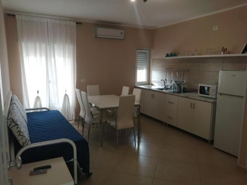 a kitchen and dining room with a table and a kitchen and a room at Villa Laura Residence Hotel Apartments & Studios in Ascea