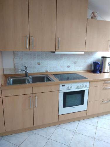 a kitchen with a sink and a stove at Bernie Apartments in Poreč