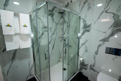 a shower stall in a bathroom with marble walls at Hotel Quinta do Viso in Miranda do Corvo