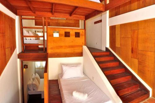 a small room with a staircase and a bunk bed at Boracay Coco Huts in Boracay