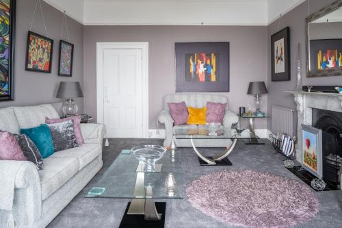 a living room with a couch and a fireplace at Highcliffe House in Lynton