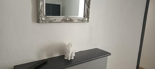 a mirror sitting on top of a counter in a room at Gîte de La Bicyclette in Montournais