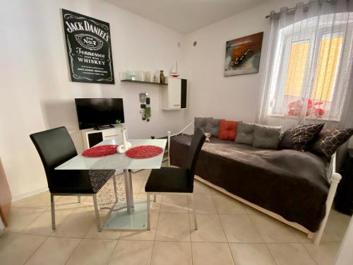 a living room with a couch and a table at Jack's Place in Trbovlje