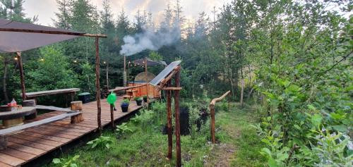 a train on a wooden platform in a forest at Agroturystyka na Słonecznej Orawie u Dzikich in Jabłonka