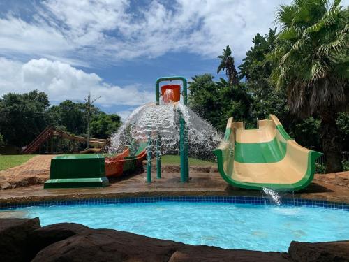 a water park with two slides in a pool at Mtunzini Forest Lodge Self Catering Resort in Mtunzini