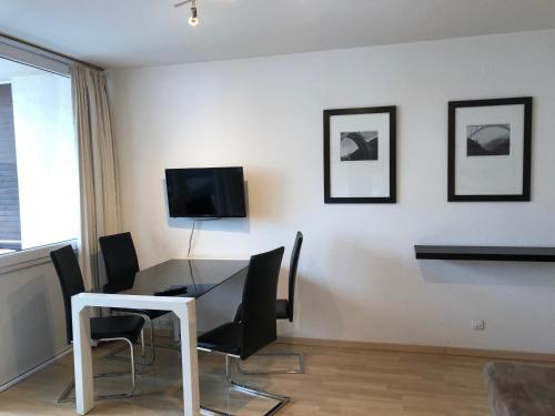 a dining room with a glass table and chairs at Appartements Domizil in Kaprun