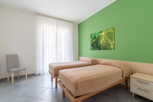 Postel nebo postele na pokoji v ubytování Terraces d'Orlando - Family Apartments with Sea View and Pool