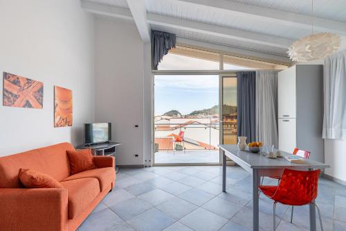 a living room with a couch and a table at Terraces d'Orlando - Family Apartments with Sea View and Pool in Capo dʼOrlando
