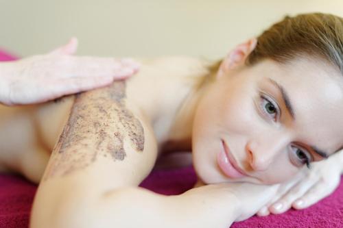 a woman with a tattoo on her arm laying on a blanket at Wald & Schlosshotel Friedrichsruhe in Friedrichsruhe