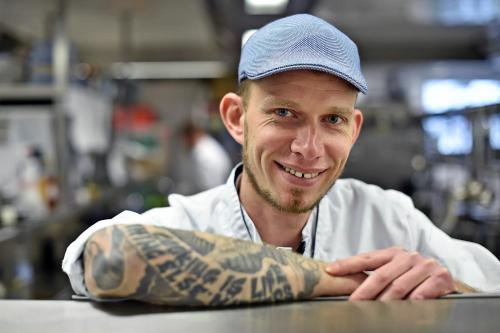a man with a tattoo on his arm at Wald & Schlosshotel Friedrichsruhe in Friedrichsruhe