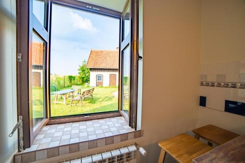 a bathroom with a window with a view of a yard at Apartament Na Skraju Miasta in Mikołajki