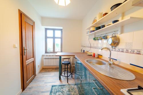 a kitchen with a sink and a counter top at Apartament Na Skraju Miasta in Mikołajki