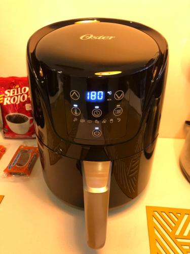 a toaster sitting on a table with a clock on it at APARTAESTUDIO AMOBLADO,FURNISHED STUDIO APARTMENT WIFI gratuito in Bogotá
