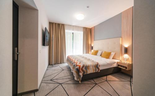 a hotel room with a bed and a window at City Park Apart Hotel by CHM in Kyiv