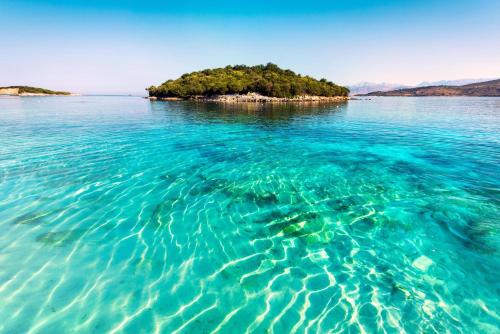 an island in the middle of a large body of water at Gregory's Apartments in Ksamil