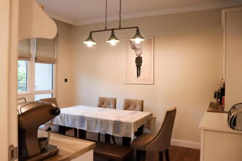 a dining room with a table and chairs at Tsarevets Apartament-Veliko Tarnovo in Veliko Tŭrnovo