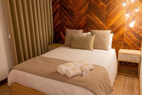 a bedroom with a bed with towels on it at Golden Mirror in Lamego