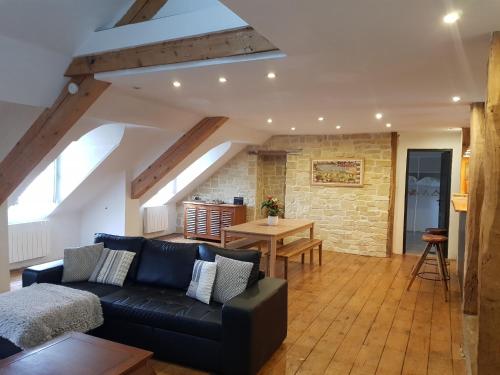 a living room with a couch and a table at Loft dans les Pyrénées in Oloron-Sainte-Marie