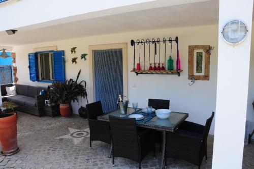 a dining room with a table and chairs at Casa Azul self-catering apartment with gorgeous biological swimming pool in Avelar