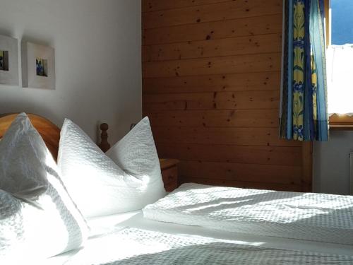 a bedroom with two beds with white pillows at Gästehaus Maier in Kitzbühel