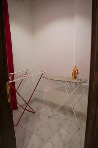 a room with a white wall and a table at ماجيك سويت بلس Magic Suite PLus in Kuwait