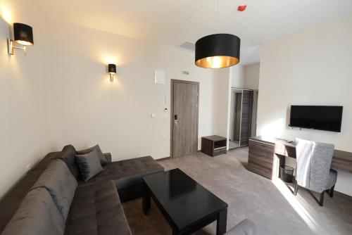 a living room with a couch and a table at Hotel Cara 28 in Skopje