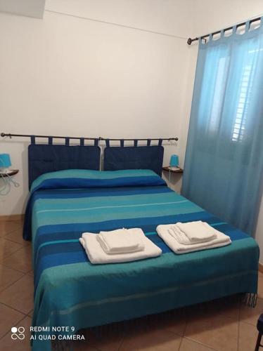 Postel nebo postele na pokoji v ubytování dammuso azzurro