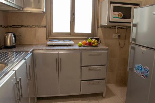 a kitchen with a bowl of fruit on the counter at ماجيك سويت بلس Magic Suite PLus in Kuwait