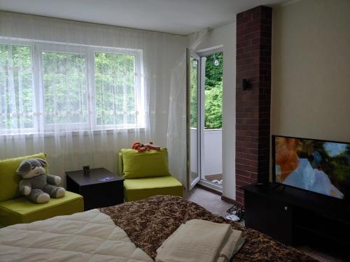 a bedroom with a teddy bear sitting on a bed at Casa Elena in Brădetu