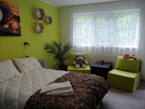 a bedroom with a bed and a teddy bear in a chair at Casa Elena in Brădetu