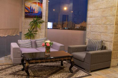 a living room with a couch and two chairs and a coffee table at ماجيك سويت بلس Magic Suite PLus in Kuwait