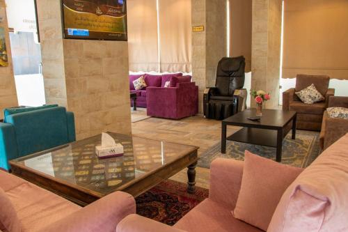 a living room with couches and a table at ماجيك سويت بلس Magic Suite PLus in Kuwait