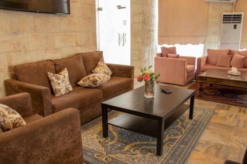 a living room with a couch and a coffee table at ماجيك سويت بلس Magic Suite PLus in Kuwait