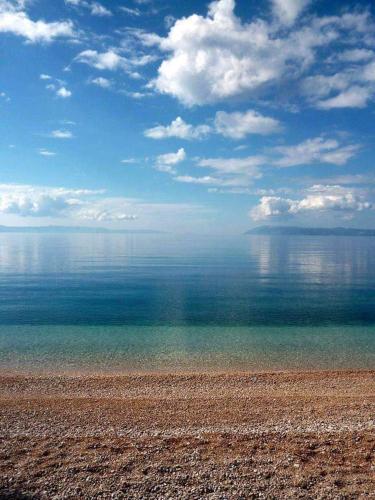 a view of the ocean from a rocky beach at Villa Pejic NEW, PENTHOUSE in Podgora