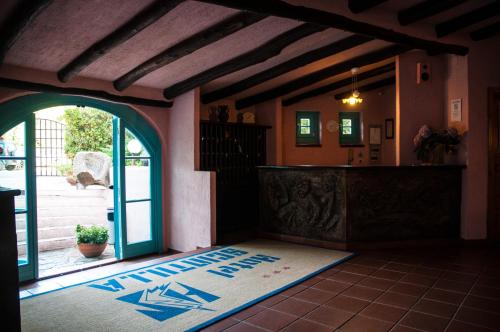 an entrance to a house with an open door at Hotel Scintilla in San Teodoro